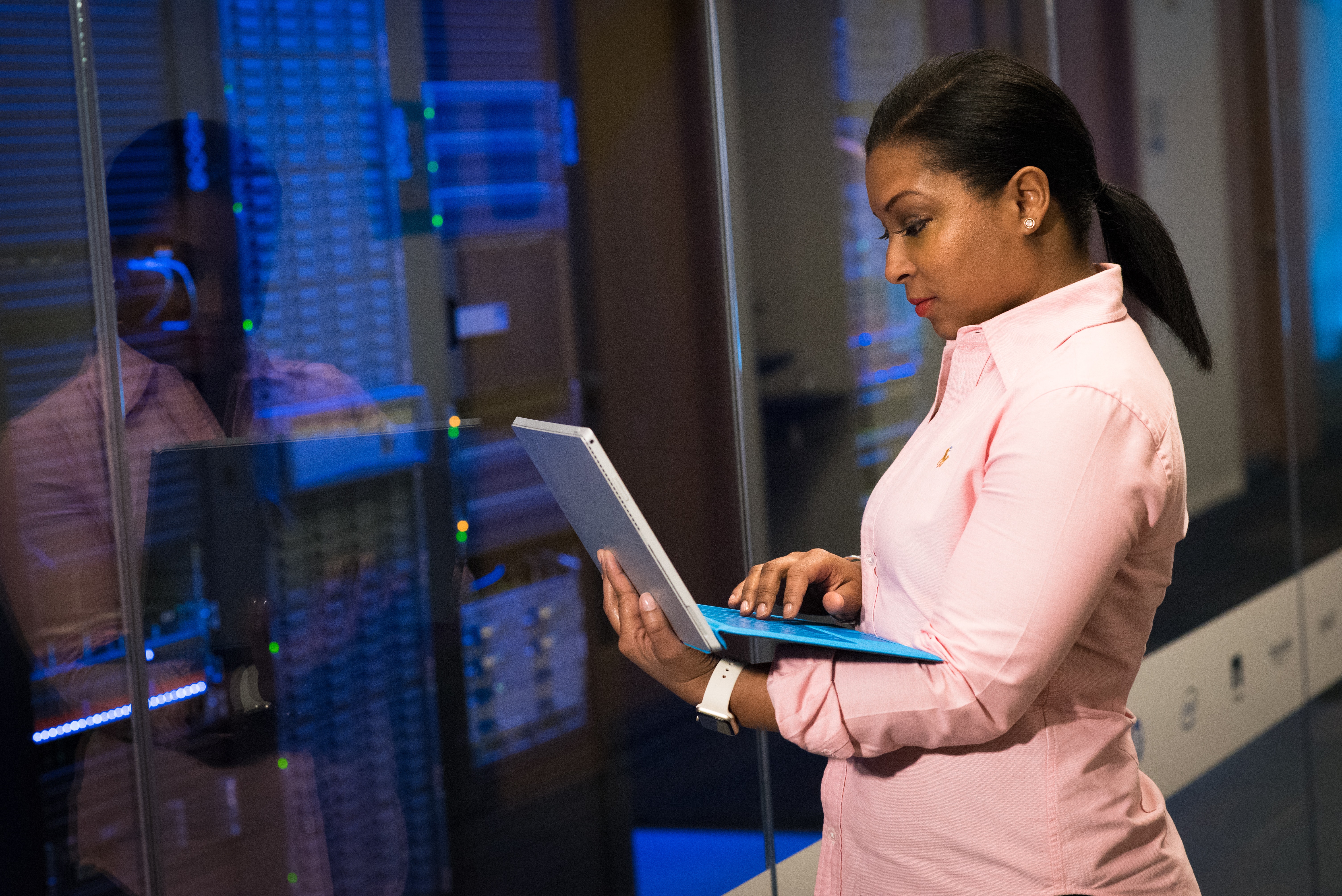 woman with laptop working on servers